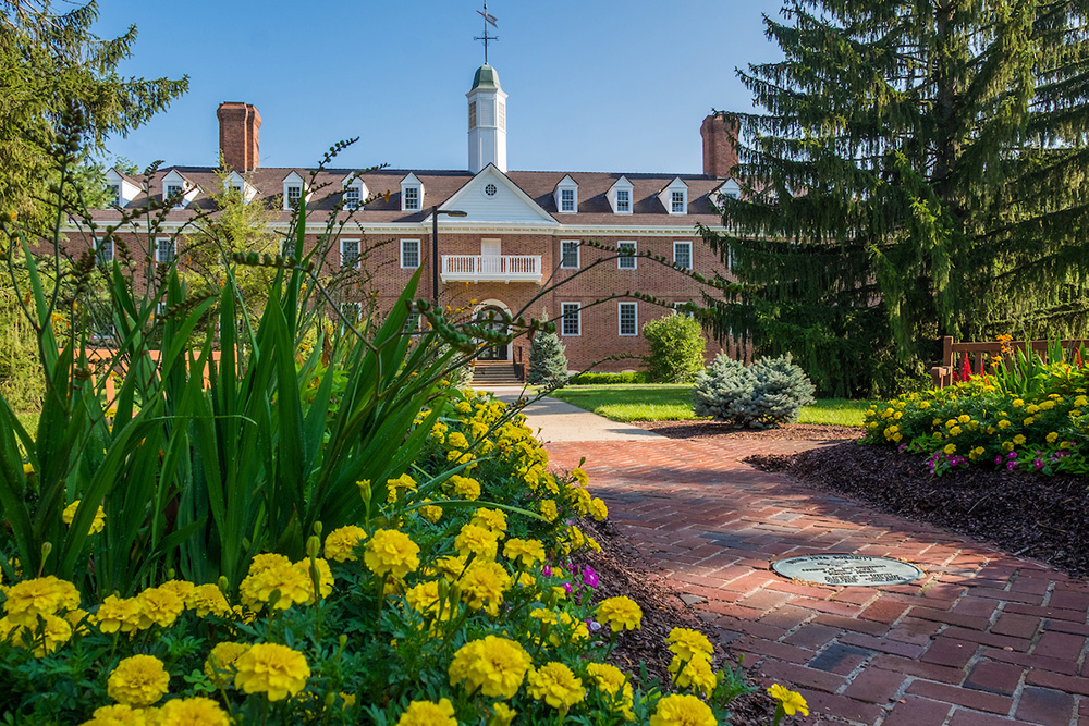 A brick academic building at Miami University in Ohio on a cloudy day with students walking past