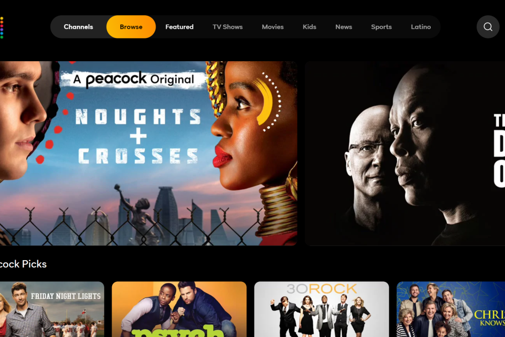 A person holding a TV remote in a living room while a streaming app interface glows on a television screen