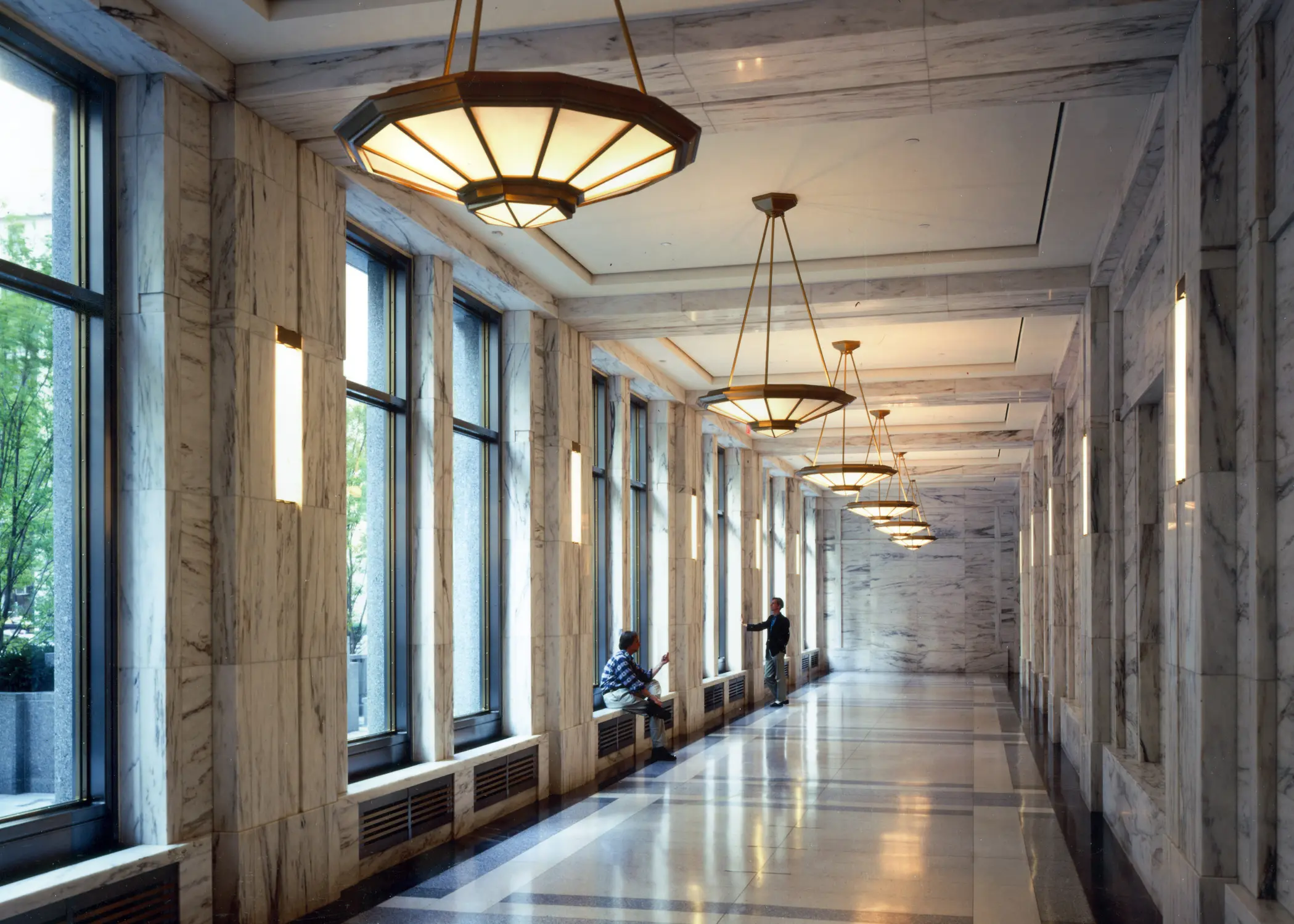A quiet courthouse hallway with wooden doors and soft overhead lighting, no visible faces