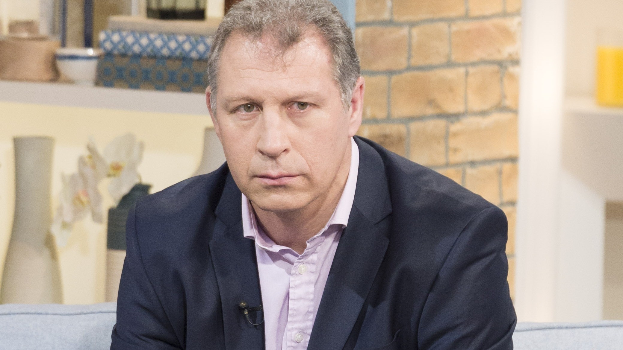 Investigator Mark Williams-Thomas speaking during an interview setup, seated and looking slightly off camera as he explains case details