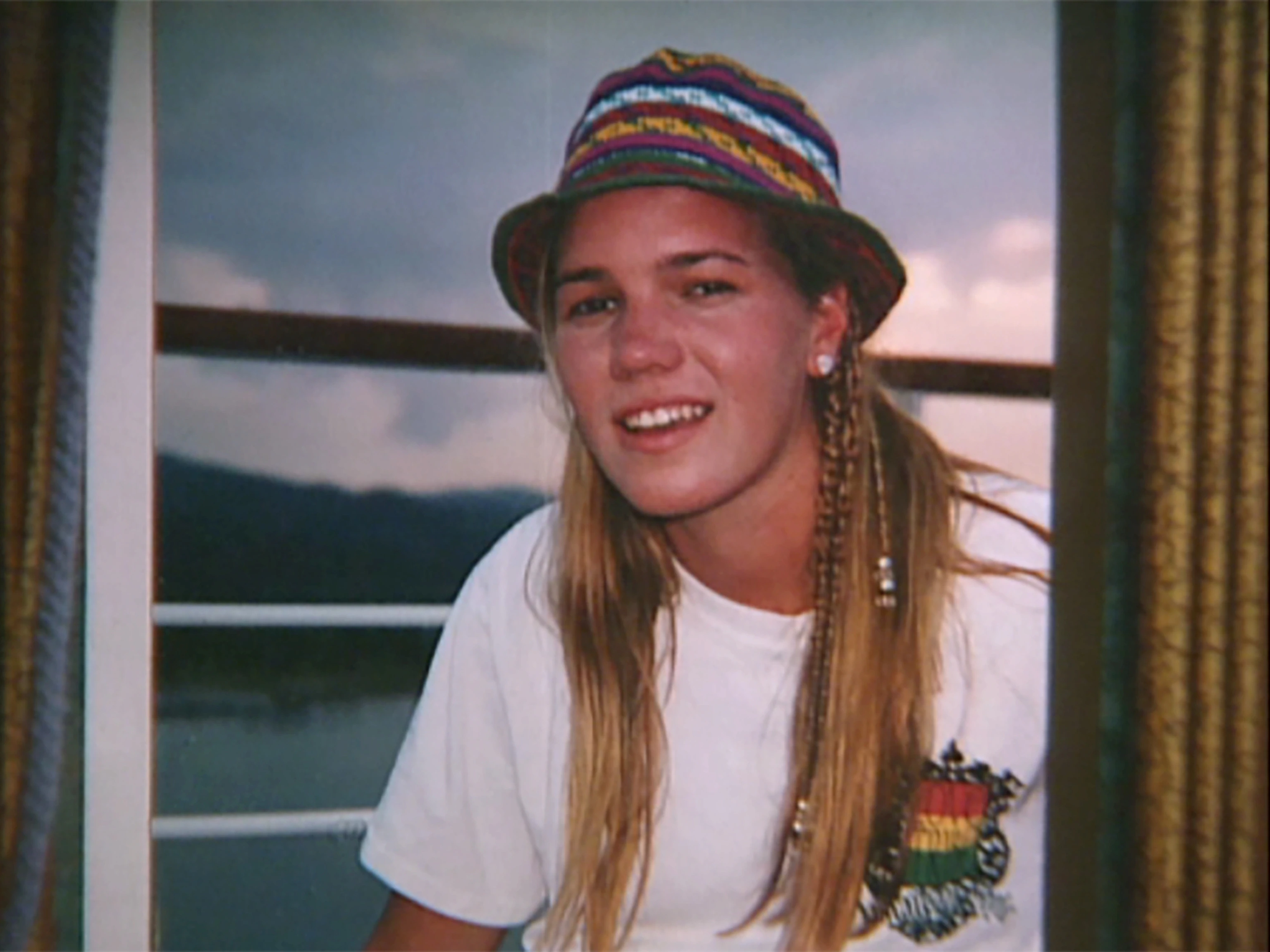 Kristin Smart smiling in a candid campus-style photograph, outdoors in daylight
