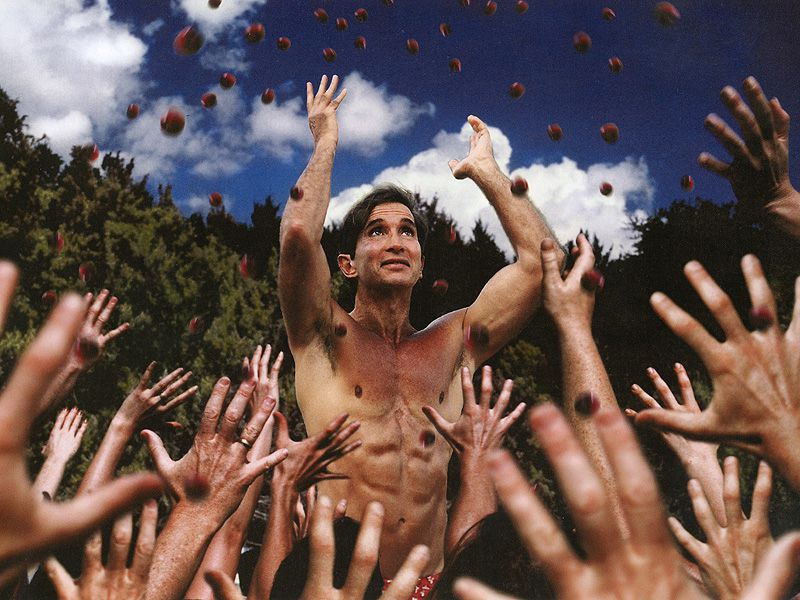 Michel Rostand standing in front of followers during a group gathering
