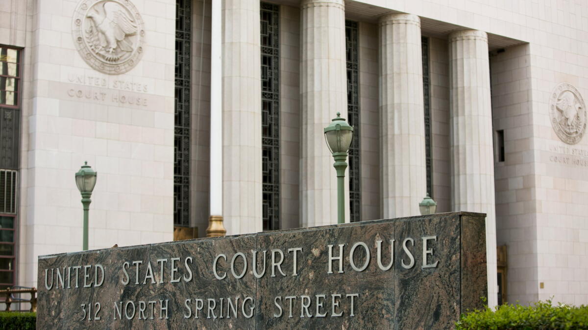 The exterior of a large federal courthouse building on a city street, with steps leading up to the entrance.